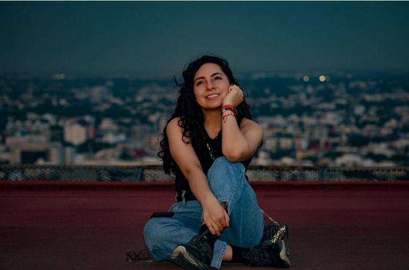 Mexican woman relaxing on rooftop