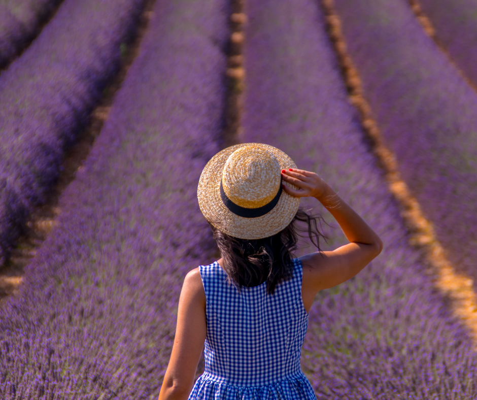 Woman walking through a field of flowers